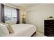 Bedroom with a window, closet, soft carpet, neutral walls, and a bedside table with a lamp at 4444 N Picadilly Ct, Aurora, CO 80019