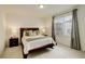Comfortable bedroom featuring a modern bed frame, soft carpet, and neutral wall colors at 4444 N Picadilly Ct, Aurora, CO 80019