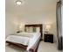 Bedroom with a dark wood bed frame, soft carpet, neutral walls, and bedside tables with lamps at 4444 N Picadilly Ct, Aurora, CO 80019