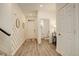 Bright and airy foyer with light wood flooring, decorative wall accents, and convenient access to a half bathroom at 4444 N Picadilly Ct, Aurora, CO 80019