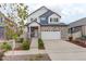 Charming two-story home featuring a stone facade, inviting entrance, and a well-maintained landscaped front yard at 4444 N Picadilly Ct, Aurora, CO 80019