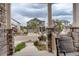 Inviting front porch with stone pillars and outdoor seating at 4444 N Picadilly Ct, Aurora, CO 80019
