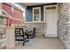Inviting front porch featuring a cozy seating area with chairs, a table, and decorative rug for relaxing outdoors at 4444 N Picadilly Ct, Aurora, CO 80019