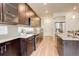 Modern kitchen with sleek dark cabinets, stainless steel appliances, and a large island perfect for entertaining at 4444 N Picadilly Ct, Aurora, CO 80019