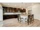 Well-appointed kitchen featuring dark cabinets, stainless steel appliances, and a central island with bar stool seating at 4444 N Picadilly Ct, Aurora, CO 80019