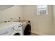 Well-lit laundry room with washer and dryer and a window at 4444 N Picadilly Ct, Aurora, CO 80019