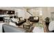 Open-concept living room featuring stylish sofas, a patterned rug, and seamless flow to the modern kitchen at 4444 N Picadilly Ct, Aurora, CO 80019