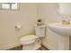 Neat powder room with pedestal sink and toilet at 4444 N Picadilly Ct, Aurora, CO 80019