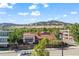 Aerial view of a charming home showcasing lush landscaping, mature trees, and mountain views at 2826 Broadway St # 106, Boulder, CO 80304