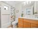 Bathroom boasts a modern vanity, a tub with a shower featuring decorative tile, and neutral finishes at 2826 Broadway St # 106, Boulder, CO 80304
