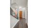 Modern hallway with glass railings, wood floors, and a solid wood front door at 2826 Broadway St # 106, Boulder, CO 80304