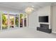 Living room with a modern fireplace, large windows overlooking a yard, and a contemporary light fixture at 2826 Broadway St # 106, Boulder, CO 80304