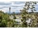 Scenic community view with lush greenery, modern buildings, and distant mountain views under a bright sky at 8774 Martin Luther King Blvd, Denver, CO 80238