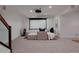 Finished basement with projector screen and comfy seating, stairs and wood banister at 8774 Martin Luther King Blvd, Denver, CO 80238
