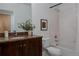 Bright bathroom featuring granite countertops, wood cabinets, and white shower and tub at 8774 Martin Luther King Blvd, Denver, CO 80238