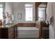 Bright bathroom with modern fixtures, a soaking tub, and a glass-enclosed shower for a spa-like experience at 8774 Martin Luther King Blvd, Denver, CO 80238