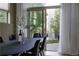 Open dining area with a modern table, sleek chairs, and sliding glass doors leading to a well-maintained outdoor space at 8774 Martin Luther King Blvd, Denver, CO 80238
