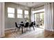 Modern dining room with hardwood floors, contemporary lighting, and a sliding glass door to the backyard at 8774 Martin Luther King Blvd, Denver, CO 80238
