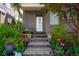 Beautifully landscaped front entrance with stone steps, colorful flowers, and a well-maintained lawn at 8774 Martin Luther King Blvd, Denver, CO 80238
