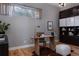 Stylish home office featuring custom built-ins, light wood flooring, and an area rug for a comfortable workspace at 8774 Martin Luther King Blvd, Denver, CO 80238