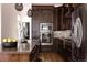 Modern kitchen featuring stainless steel appliances, dark cabinetry, island with bar stool seating, and tile backsplash at 8774 Martin Luther King Blvd, Denver, CO 80238