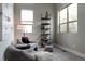 Comfortable living room space with soft chairs, natural light, and modern shelving for a serene ambiance at 8774 Martin Luther King Blvd, Denver, CO 80238