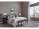 Serene main bedroom with a plush bed, ample natural light from large windows, and stylish decor at 8774 Martin Luther King Blvd, Denver, CO 80238