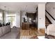 Bright open concept showcases the kitchen and living room with hardwood floors and stylish finishes at 8774 Martin Luther King Blvd, Denver, CO 80238