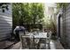 A cozy outdoor patio features a dining table and grill, perfect for entertaining guests outside at 8774 Martin Luther King Blvd, Denver, CO 80238