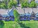 Aerial view of townhomes with private decks, surrounded by lush greenery and manicured lawns at 9771 W Cornell Pl, Lakewood, CO 80227