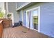 Back deck with wood flooring, siding, and sliding glass door access at 9771 W Cornell Pl, Lakewood, CO 80227