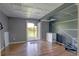 Finished basement with white ceiling tile, wood-look floors, and walkout to patio at 9771 W Cornell Pl, Lakewood, CO 80227
