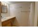 Bright bathroom includes white shower curtain, vanity, and open space at 9771 W Cornell Pl, Lakewood, CO 80227
