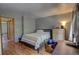 Bedroom with laminate wood floor, desk, and chest of drawers at 9771 W Cornell Pl, Lakewood, CO 80227