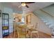 Dining area with views to kitchen and stairs, featuring laminate flooring and contemporary ceiling at 9771 W Cornell Pl, Lakewood, CO 80227