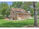 Charming stone house with mature trees, a well-maintained lawn, and inviting curb appeal at 9771 W Cornell Pl, Lakewood, CO 80227