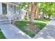 Street view of well-maintained townhomes with established trees and landscaping along the sidewalk at 9771 W Cornell Pl, Lakewood, CO 80227