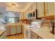 Charming kitchen with appliances, ample counter space, and open view to the living area at 9771 W Cornell Pl, Lakewood, CO 80227