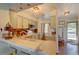 Bright kitchen featuring an eat-in bar, with view to the front entry and vinyl flooring at 9771 W Cornell Pl, Lakewood, CO 80227