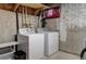 Unfinished basement laundry area with washer and dryer hookups at 9771 W Cornell Pl, Lakewood, CO 80227
