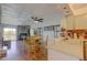 Bright, open-concept living area featuring dining space, kitchen access and contemporary lighting at 9771 W Cornell Pl, Lakewood, CO 80227