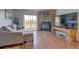 Inviting living room featuring hardwood floors, natural lighting, and a stone fireplace at 9771 W Cornell Pl, Lakewood, CO 80227