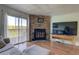 Living area featuring wood floors, fireplace, sliding glass door, and decorative ceiling at 9771 W Cornell Pl, Lakewood, CO 80227