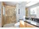 Bathroom with a glass-enclosed shower, granite countertop, and warm neutral tones at 30633 Kings Valley Dr, Conifer, CO 80433