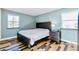 Comfortable bedroom with stylish floors, two windows, and ample natural light at 30633 Kings Valley Dr, Conifer, CO 80433