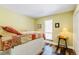 Bedroom featuring window, a dresser used as a night stand, and stylish flooring at 30633 Kings Valley Dr, Conifer, CO 80433