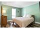 Inviting bedroom featuring hardwood floors, a comfortable bed, and ample natural light at 30633 Kings Valley Dr, Conifer, CO 80433