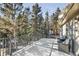 Expansive deck overlooking lush trees with comfortable seating, perfect for enjoying serene outdoor living at 30633 Kings Valley Dr, Conifer, CO 80433