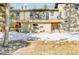 Rear exterior featuring a deck with railing and ground-level covered patio at 30633 Kings Valley Dr, Conifer, CO 80433