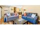 Open living room with hardwood floors and comfortable seating and views of the dining room at 30633 Kings Valley Dr, Conifer, CO 80433